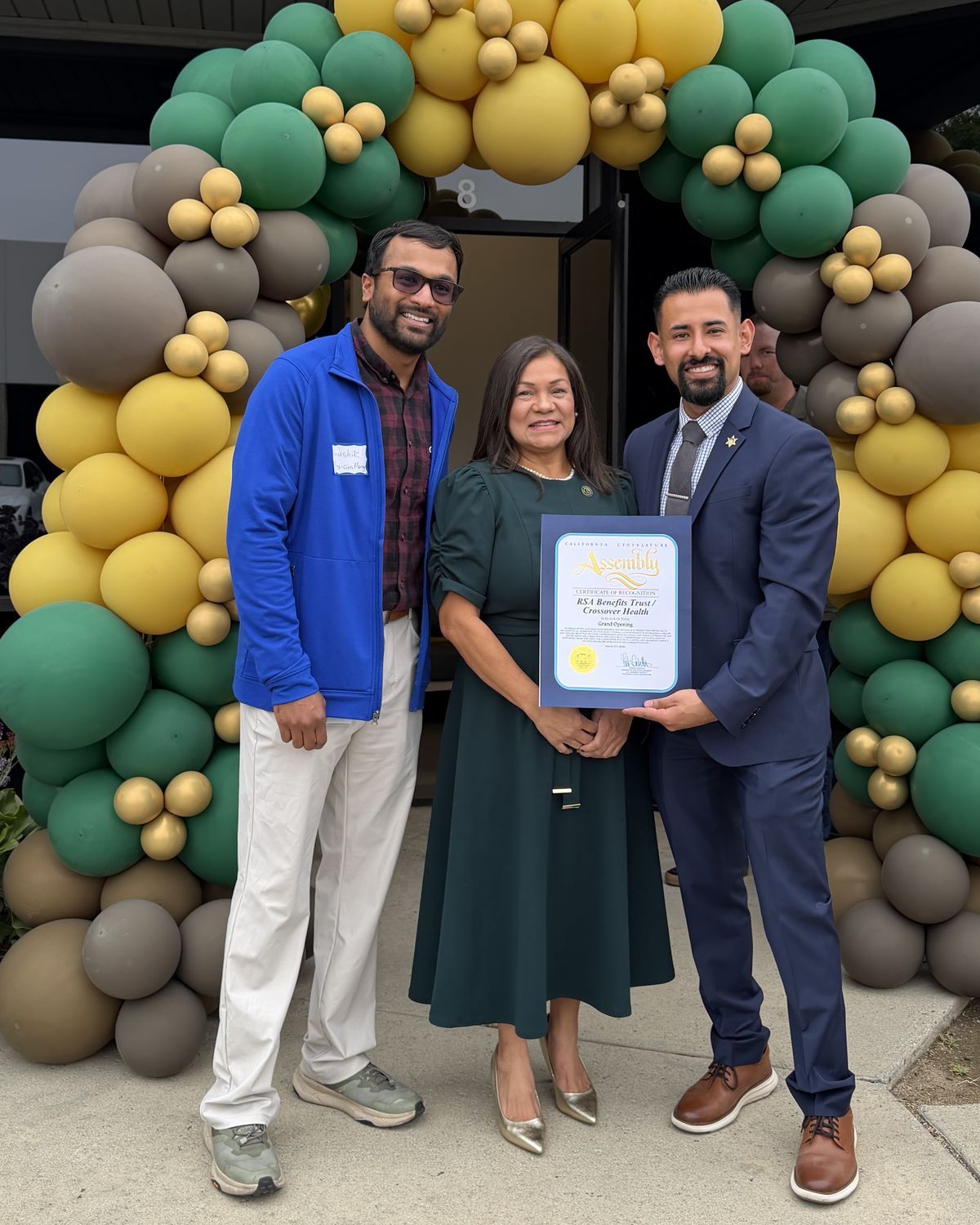 Jose Santos at the RSA Benefits Trust and Crossover Health grand opening, holding a California State Assembly Certificate of Recognition